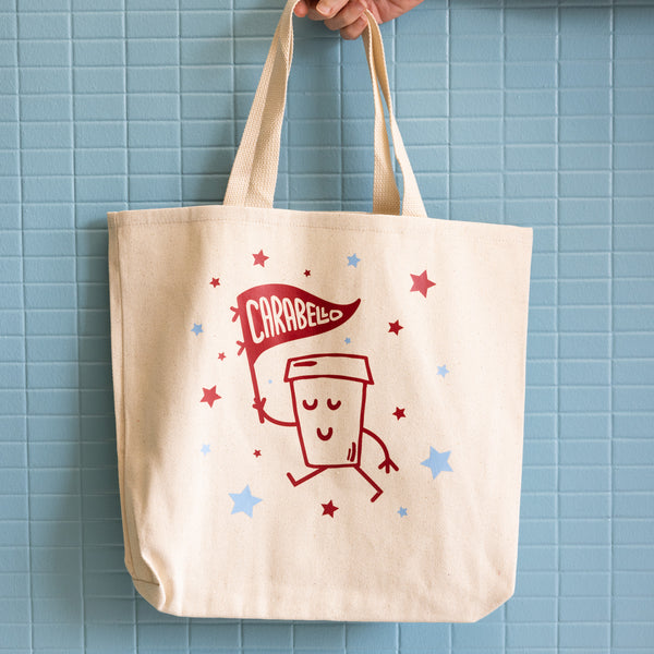 Canvas tote with cartoon cup marching with a Carabello banner