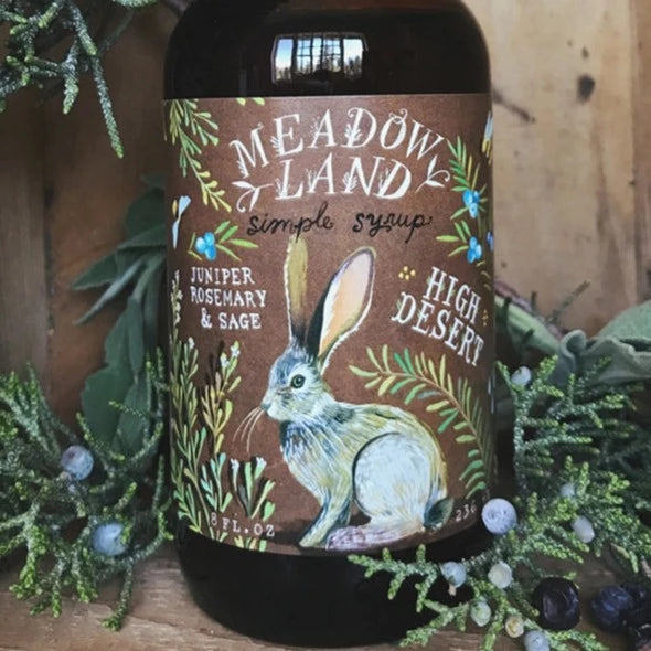 Meadowland brand syrup flavored with juniper, rosemary and sage.  Brown 8 oz bottle with rabbit on it, titled High Desert Syrup