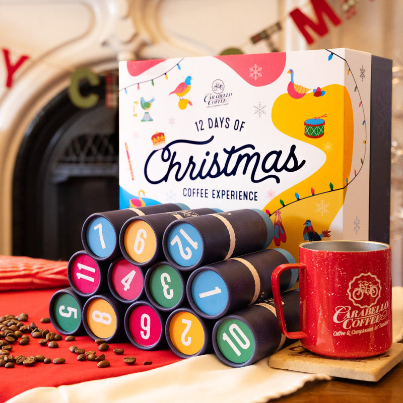 12 Days of Christmas coffee experience box with a red mug and coffee beans on a festive background.