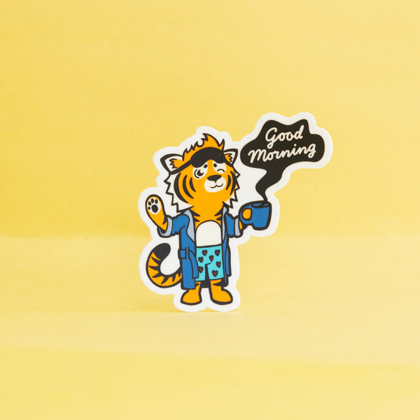 Cartoon tiger character holding a coffee cup with 'Good Morning' text on a yellow background
