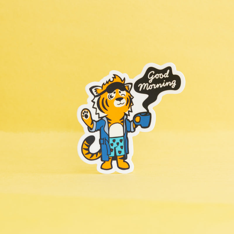 Cartoon tiger character holding a coffee cup with 'Good Morning' text on a yellow background