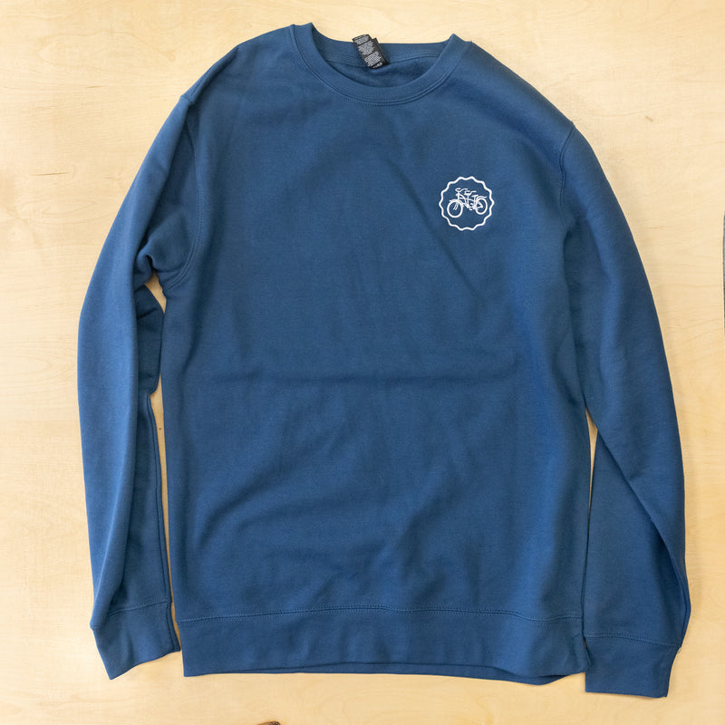 Blue sweatshirt with a logo on a beige background