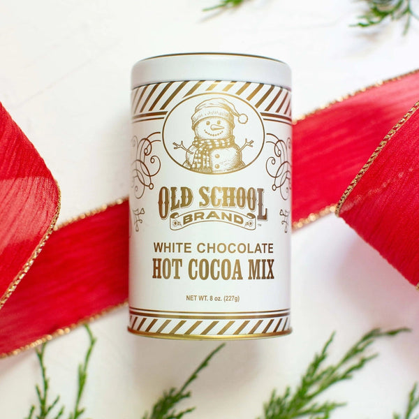 Canister of Old School Brands white chocolate hot cocoa mix with decorative elements on a light background