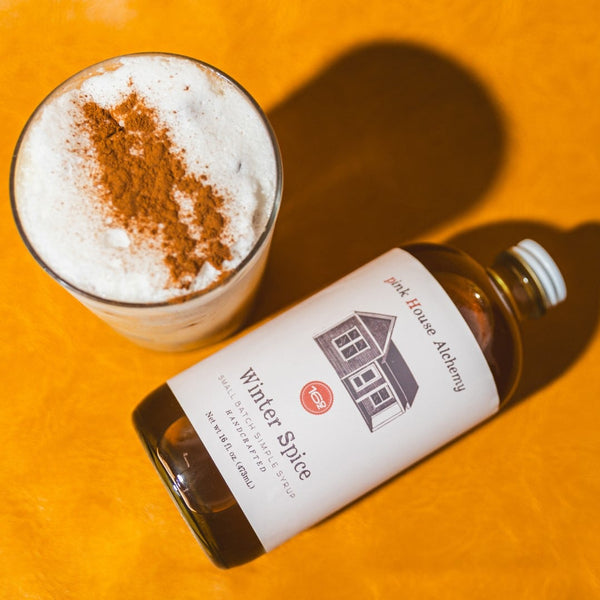 Bottle of Winter Spice syrup and a drink 
