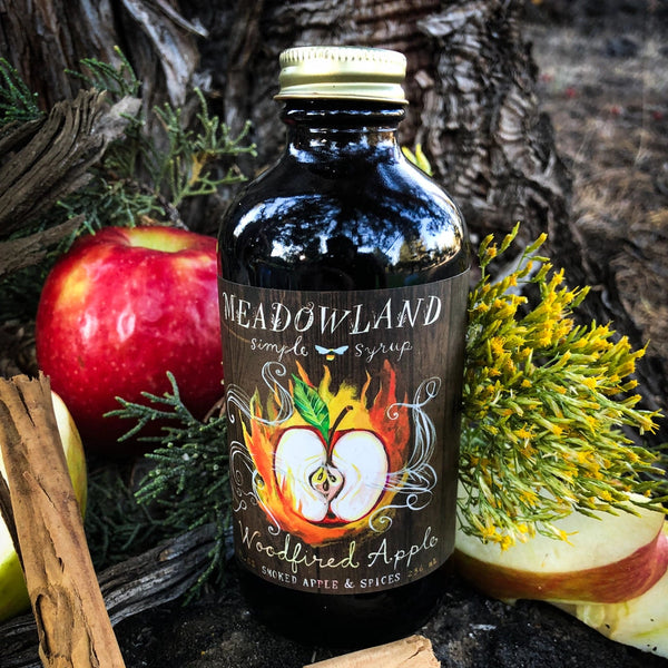 Apple syrup with apple slices and cinnamon sticks 
