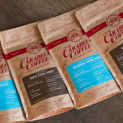 Image of four Single Origin coffees available with this product. Coffees vary from image, and are chosen form our current stock. Click image for product info or to view.
